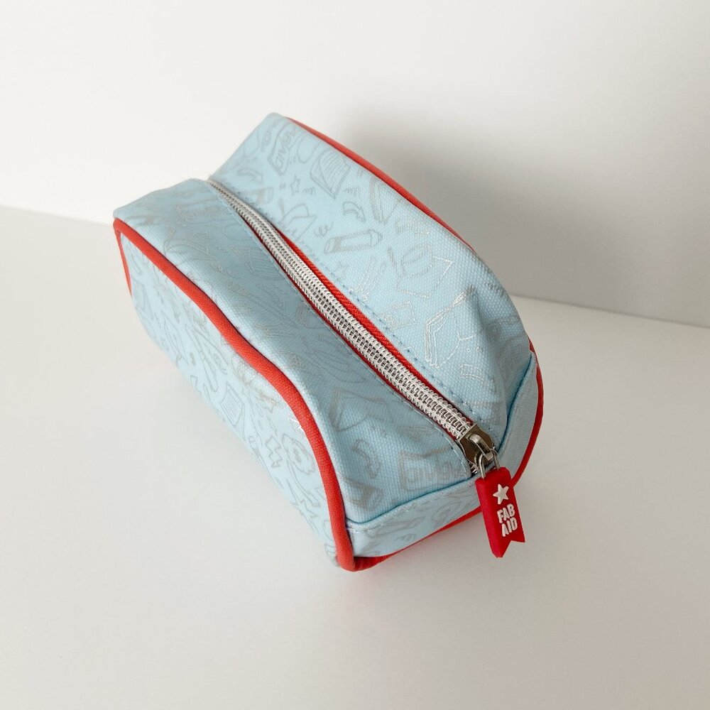 First Aid Beauty Makeup Organizer Travel Bag Light Blue Red Interior and Border